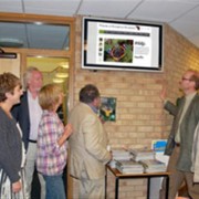 Members of the committee view the new website with the 
web developer Peter Smith (far right).